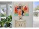 Living area showcasing artistic décor, a decorative cabinet, and natural light from the window at 703 Valencia Shores Dr, Winter Garden, FL 34787