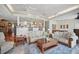 Open floor plan living area with a view into the kitchen, cozy seating, and decorative ceiling at 703 Valencia Shores Dr, Winter Garden, FL 34787