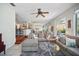 Spacious living room featuring stylish decor, ceiling fan, and access to other rooms at 703 Valencia Shores Dr, Winter Garden, FL 34787