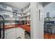 Walk-in pantry with custom shelving and easy access to the kitchen at 703 Valencia Shores Dr, Winter Garden, FL 34787