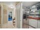 Walk-in pantry with custom shelving, stainless appliances, and sink at 703 Valencia Shores Dr, Winter Garden, FL 34787
