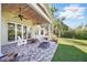 A paver patio with stone steps includes ceiling fans and an outdoor fireplace at 703 Valencia Shores Dr, Winter Garden, FL 34787
