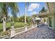 A paver patio with a decorative stone railing overlooks the lawn at 703 Valencia Shores Dr, Winter Garden, FL 34787