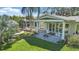 Outdoor living at its finest with a covered patio, screened in porch, and beautiful green landscaping at 703 Valencia Shores Dr, Winter Garden, FL 34787