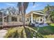 Charming home boasts a covered patio, stone balustrade, lush lawn, and inviting outdoor spaces at 703 Valencia Shores Dr, Winter Garden, FL 34787