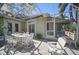 A screened patio with dining table and chairs and ceiling fan at 703 Valencia Shores Dr, Winter Garden, FL 34787