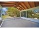 A screened porch with wood paneled ceiling looks out onto green landscaping at 703 Valencia Shores Dr, Winter Garden, FL 34787