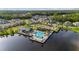 Aerial view of a community pool, playground, and surrounding homes nestled by a serene lake and lush greenery at 737 Hyperion Dr, Debary, FL 32713
