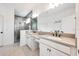 Bathroom featuring double vanities, a large mirror, and a walk-in shower with tile surround at 737 Hyperion Dr, Debary, FL 32713