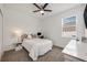 A cozy bedroom with a ceiling fan, a comfortable bed, and a bright window at 737 Hyperion Dr, Debary, FL 32713