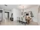Dining room with a rustic wooden table and modern light fixture, adjacent to the kitchen at 737 Hyperion Dr, Debary, FL 32713