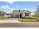 Charming two-story home featuring a two-car garage, stone accents, and well-maintained landscaping at 737 Hyperion Dr, Debary, FL 32713