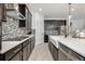 Stylish kitchen featuring dark cabinetry, stainless steel appliances, and a farmhouse sink at 737 Hyperion Dr, Debary, FL 32713