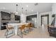 Modern kitchen with stainless steel appliances, dark cabinets, a waterfall island, and pendant lighting at 737 Hyperion Dr, Debary, FL 32713