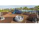 Community playground with a slide and climbing structures next to a pool, perfect for outdoor fun at 737 Hyperion Dr, Debary, FL 32713