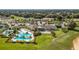 Beautiful aerial view of a community pool, clubhouse, and picturesque landscaping at 7928 Hanson Bay Pl, Kissimmee, FL 34747