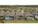 Aerial back exterior shot of homes with screened-in lanais, patios, and pools at 7928 Hanson Bay Pl, Kissimmee, FL 34747