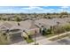 Aerial view of a home with a 3-car garage, well-maintained landscaping, and neighborhood at 7928 Hanson Bay Pl, Kissimmee, FL 34747
