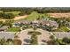 Aerial view of clubhouse featuring lush landscaping, sidewalks, and circular driveway at 7928 Hanson Bay Pl, Kissimmee, FL 34747