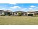 Backyard with lush green lawn and screened-in patios at 7928 Hanson Bay Pl, Kissimmee, FL 34747