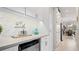 Charming bar area with herringbone backsplash, mini fridge, and 