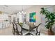 Bright dining room features a modern chandelier, stylish table with seating for eight, and adjacent to the kitchen at 7928 Hanson Bay Pl, Kissimmee, FL 34747