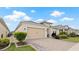 A beautiful home with a beige garage door, paver driveway, and lush landscaping at 7928 Hanson Bay Pl, Kissimmee, FL 34747