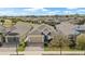 Aerial front exterior shot of a well-maintained home with a three-car garage and manicured landscaping at 7928 Hanson Bay Pl, Kissimmee, FL 34747