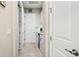 Hallway featuring neutral walls and floors, white doors, and access to rooms at 7928 Hanson Bay Pl, Kissimmee, FL 34747