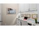Bright home office featuring white cabinetry, desk space, and a calming beach view decal at 7928 Hanson Bay Pl, Kissimmee, FL 34747