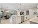 Open-concept kitchen with a large island, pendant lights, and seamless flow to the dining and living areas at 7928 Hanson Bay Pl, Kissimmee, FL 34747
