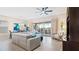 The open living area offers a sectional sofa, lanai access, and adjacent dining at 7928 Hanson Bay Pl, Kissimmee, FL 34747