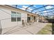 Screened-in lanai with an outdoor seating area and a built-in outdoor kitchen at 7928 Hanson Bay Pl, Kissimmee, FL 34747