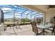 Covered patio with outdoor dining set and serene backyard view at 7928 Hanson Bay Pl, Kissimmee, FL 34747