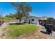 Lush backyard featuring a well-maintained lawn, mature tree, wooden privacy fence, and brick pavers at 812 Arlington Blvd, Altamonte Springs, FL 32701