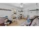 Bright bedroom with floral wallpaper border, ceiling fan, large window, and closet with wooden slat doors at 812 Arlington Blvd, Altamonte Springs, FL 32701