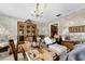 Charming dining room with ornate chandelier, classic china cabinet, and vintage wallpaper for an elegant entertaining space at 812 Arlington Blvd, Altamonte Springs, FL 32701