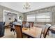 Classic dining room with a wooden table, ornate chandelier, and floral wallpaper for a warm, inviting atmosphere at 812 Arlington Blvd, Altamonte Springs, FL 32701