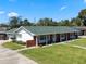 A charming single-story home featuring a brick facade, white columns, and a well-manicured lawn at 812 Arlington Blvd, Altamonte Springs, FL 32701