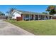 Single-story home featuring a brick facade, white columns, and a well-manicured lawn at 812 Arlington Blvd, Altamonte Springs, FL 32701