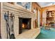 Close-up of a brick fireplace with fire tools and a rocking chair, creating a warm, inviting focal point in the room at 812 Arlington Blvd, Altamonte Springs, FL 32701