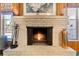 Cozy brick fireplace with a warm fire and vintage accents at 812 Arlington Blvd, Altamonte Springs, FL 32701