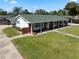 A charming single-story home featuring a brick facade, white columns, and a well-manicured lawn, and solar panels at 812 Arlington Blvd, Altamonte Springs, FL 32701