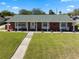 Charming single-story home featuring a brick facade, white columns, and a well-manicured lawn, offering great curb appeal at 812 Arlington Blvd, Altamonte Springs, FL 32701