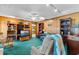 Cozy living room featuring wood paneling, display shelves, and a ceiling fan, ideal for relaxation and entertainment at 812 Arlington Blvd, Altamonte Springs, FL 32701