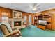 Inviting living room featuring a brick fireplace, wood paneling, and comfortable seating, perfect for cozy evenings at 812 Arlington Blvd, Altamonte Springs, FL 32701