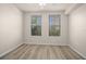 A bedroom with modern wood floors, ceiling fan, and windows with mini blinds at 911 N Orange Ave # 447, Orlando, FL 32801