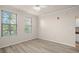 This is a bright, airy bedroom with wood-look floors and two windows at 911 N Orange Ave # 447, Orlando, FL 32801