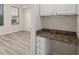 Bedroom with built-in desk area, two windows, and wood-look floors at 911 N Orange Ave # 447, Orlando, FL 32801