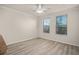 Bright bedroom featuring hardwood floors, ceiling fan, and natural light from large windows at 911 N Orange Ave # 447, Orlando, FL 32801